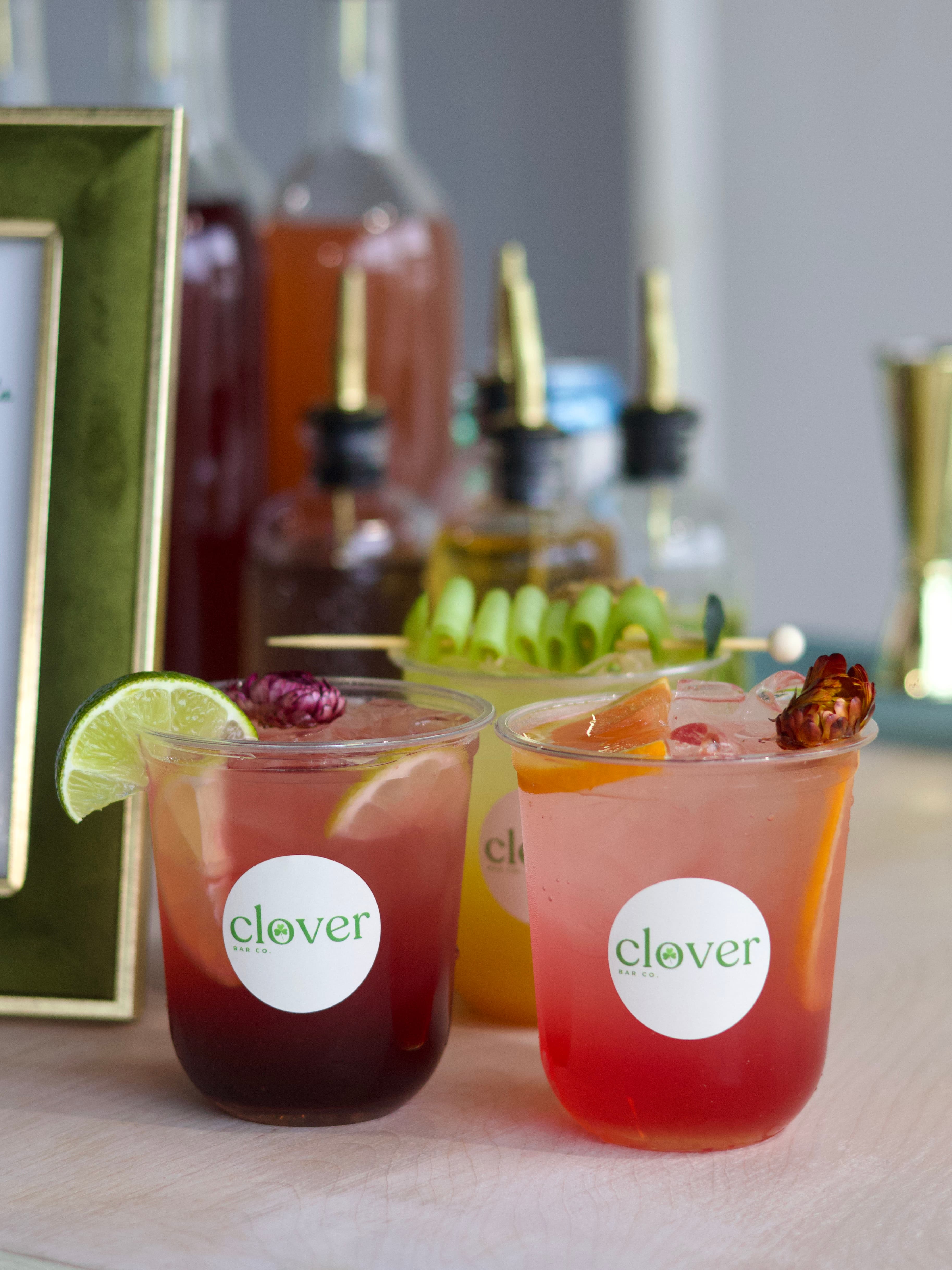 Sydni standing behind the Clover mobile bar at an event.