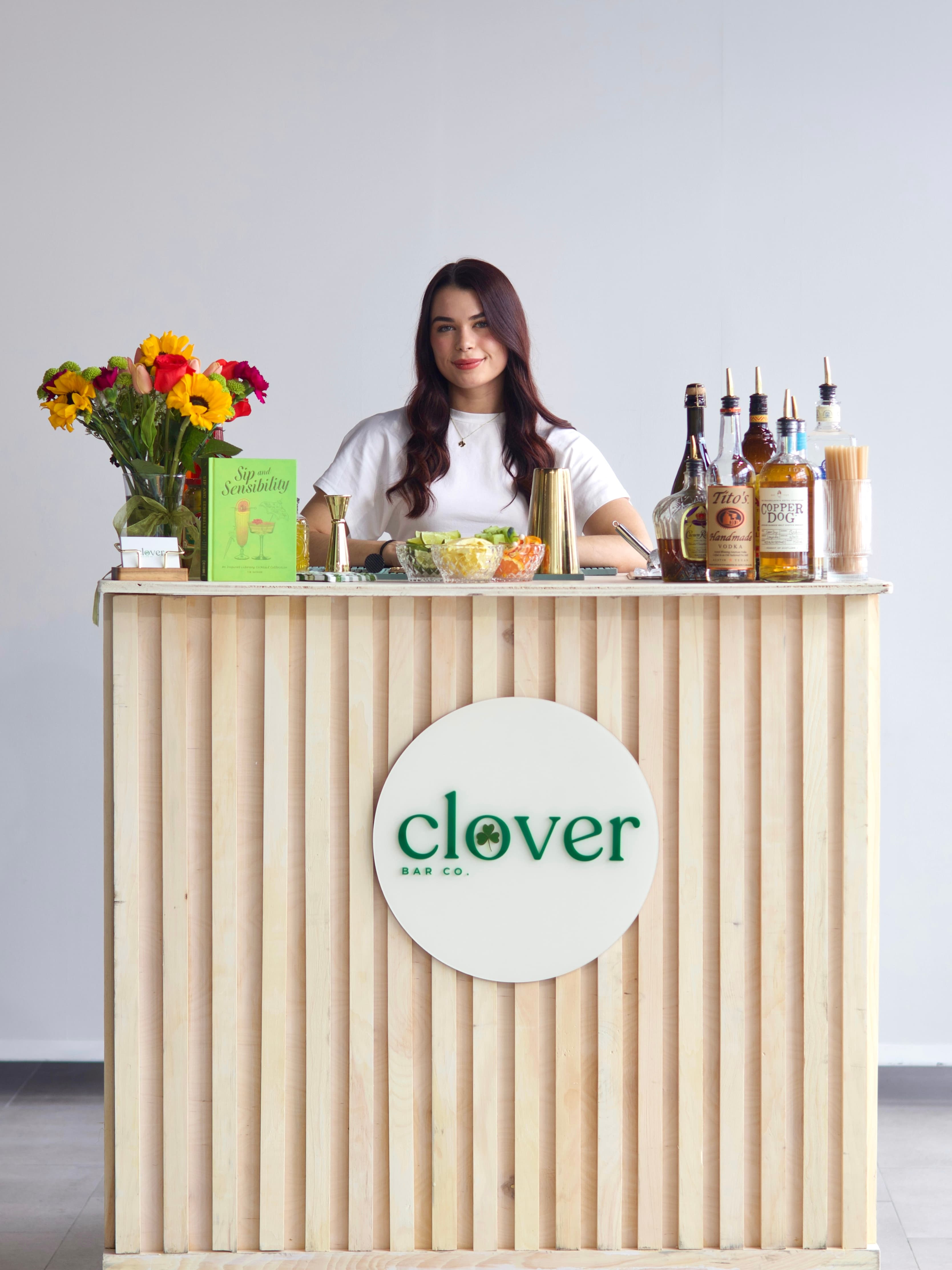 Fresh mixers, hand-cut garnishes, and bar tools arranged on the Clover bar.