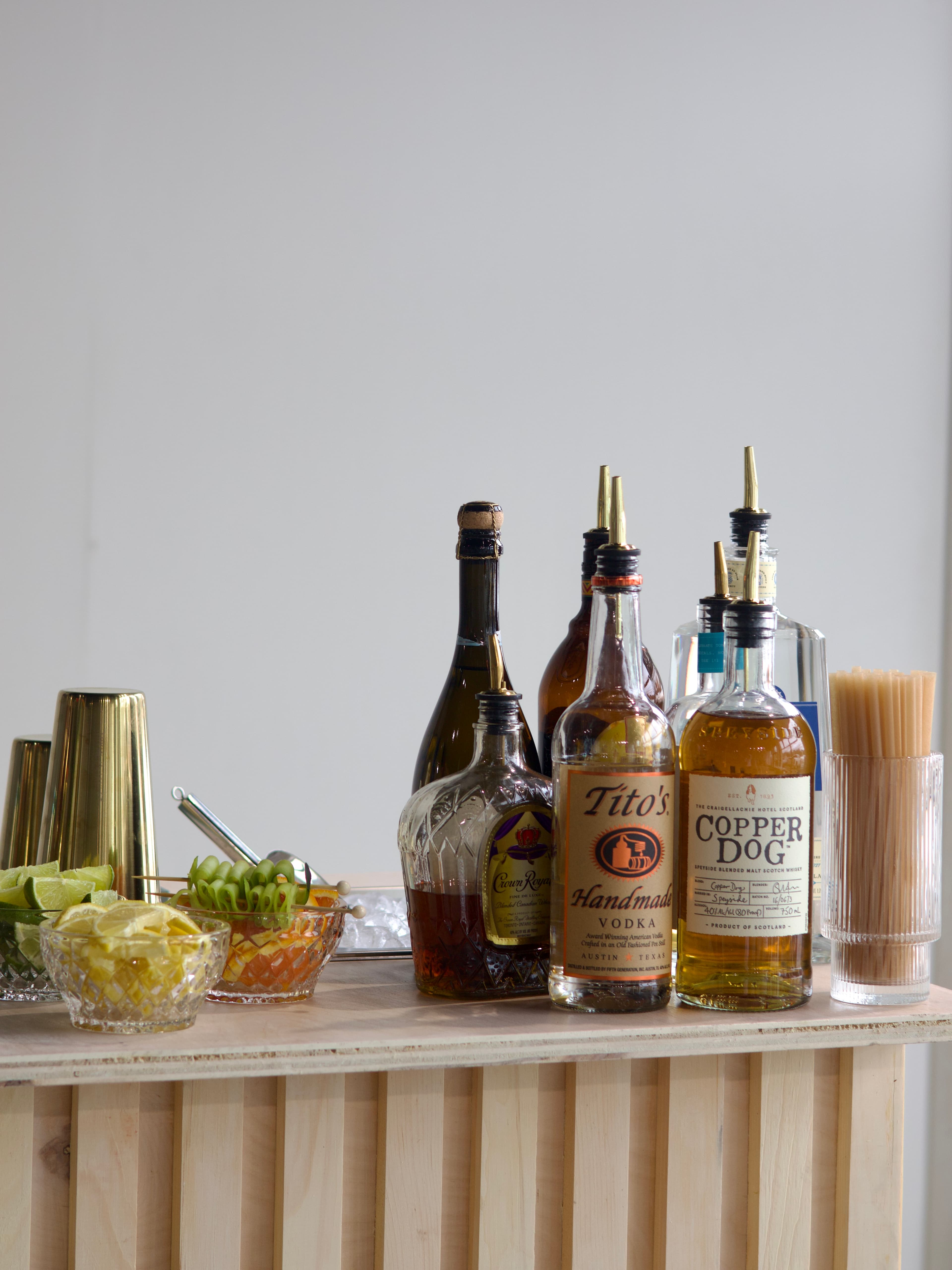 The Clover mobile bar styled with florals, menus, and cocktail glassware.